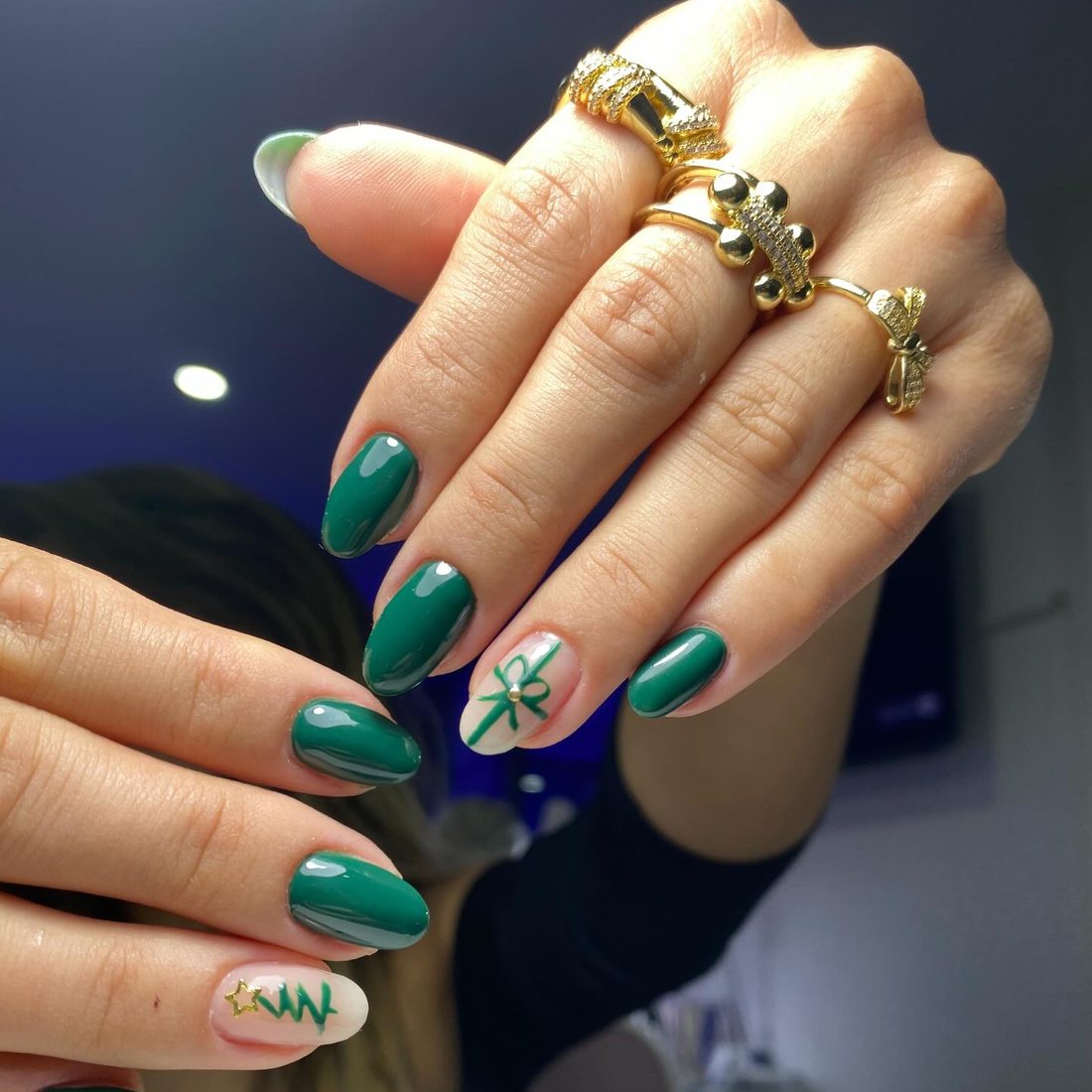 Zümrüt yeşili badem tırnak, altın nail art ve altın yüzükler